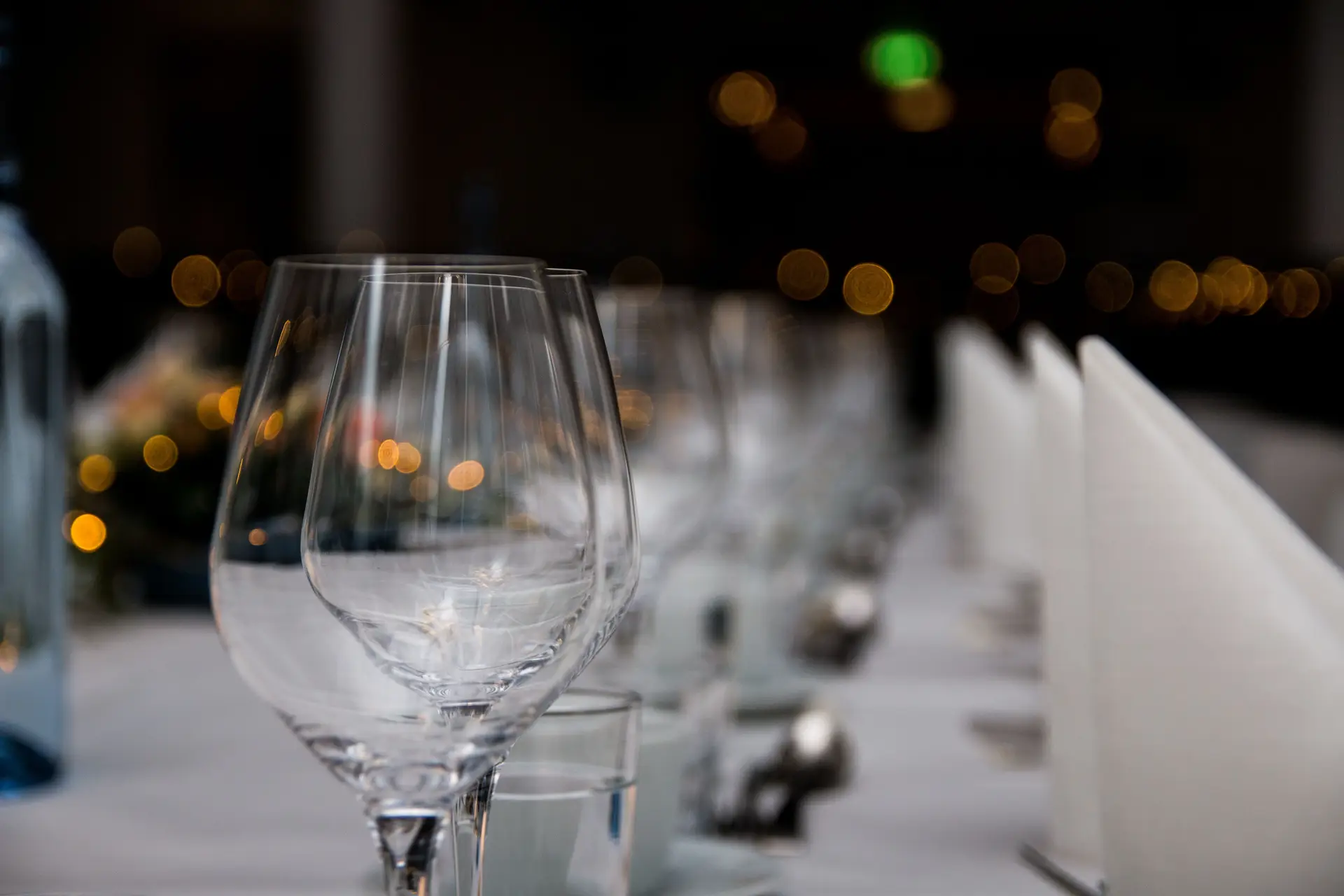 Dinner table with glassware and warm lighting